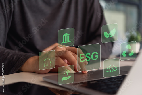 A person interacts with a digital interface showing icons related to ESG (Environmental, Social, Governance) principles.. photo