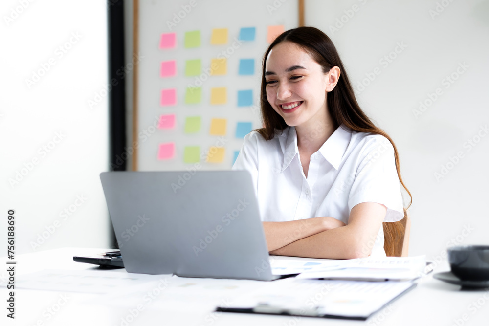 Asian businesswoman sit at their desks and calculate financial graphs showing results about their investments, plan a successful business growth process Asian businesswoman sit at their desks and calculate financial graphs showing results about their investments, plan a successful business growth process