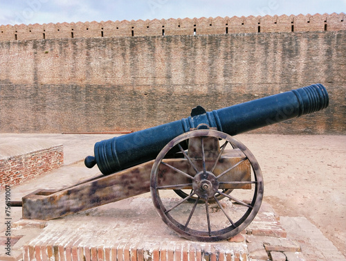 Old cannon gun ancient war weapon in a fort  canhao toap top-gun cannone antique-cannon iron-cannon wheel-cannon kanone artillery barrel army firearm in a castle photo  photo
