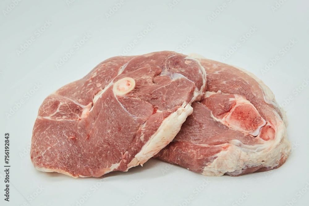 Raw meat on a white background. Pork, beef or lamb. Steak or tenderloin. Different parts of meat products for different dishes. Raw meat on a white background. Pork, beef or lamb. Steak or tenderloin. Different parts of meat products for different dishes.