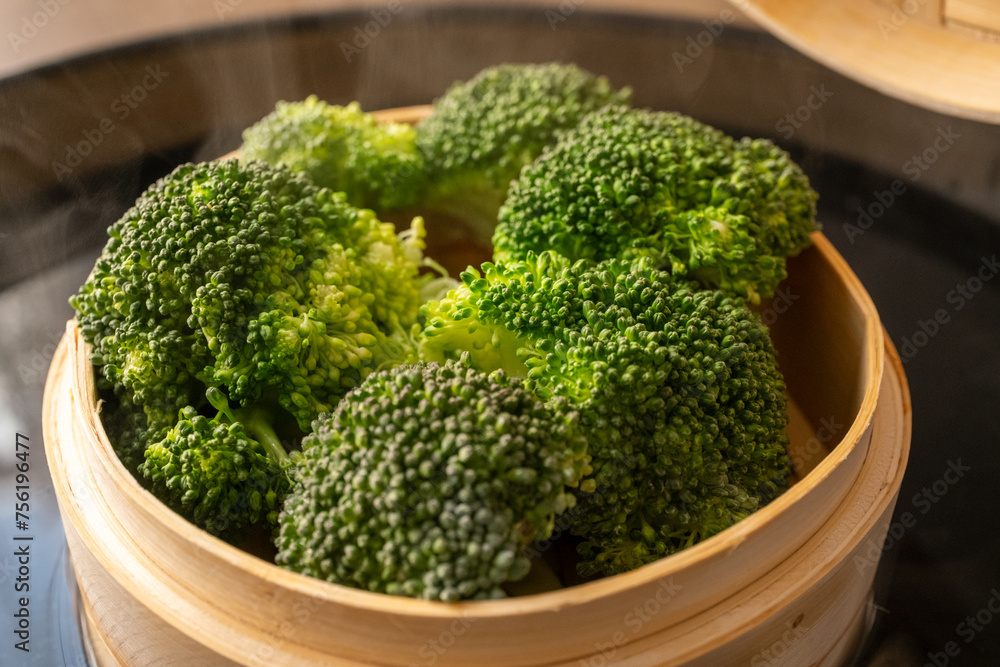 boil steaming broccoli with bamboo steamer on black surface
boil steaming broccoli with bamboo steamer on black surface