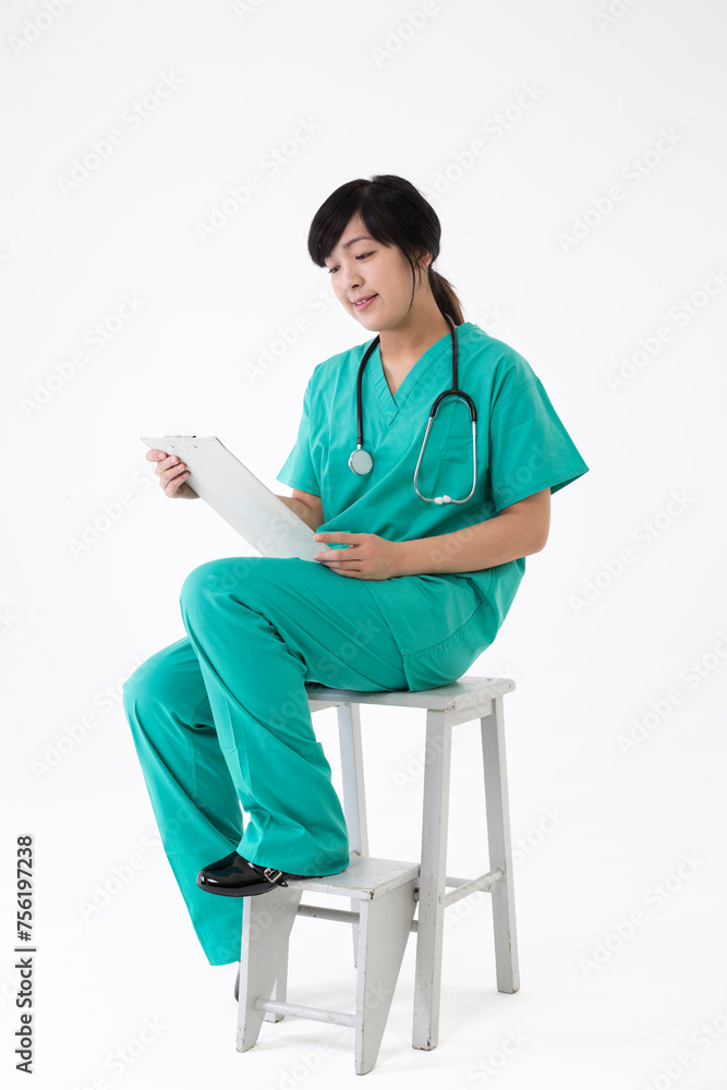 Female Asian doctor wearing a green scrubs and stethoscope Stock Photo ...