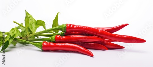 A bunch of red chili peppers with green leaves, known as Chile de rbol, is a staple ingredient in many cuisines. This natural food adds a spicy kick to dishes and is a popular vegetable produce photo