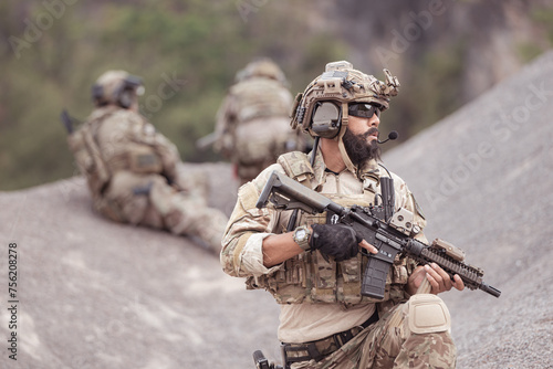 Obraz na plátne Soldiers in camouflage military uniforms carrying weapons, Reconnaissance missions in rugged mountains, Assault infantry battle training