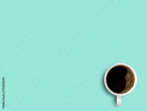 Cup of coffee on green table background.