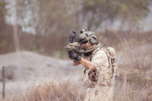 Soldiers in camouflage military uniforms carrying weapons, Reconnaissance missions in rugged mountains, Assault infantry battle training.