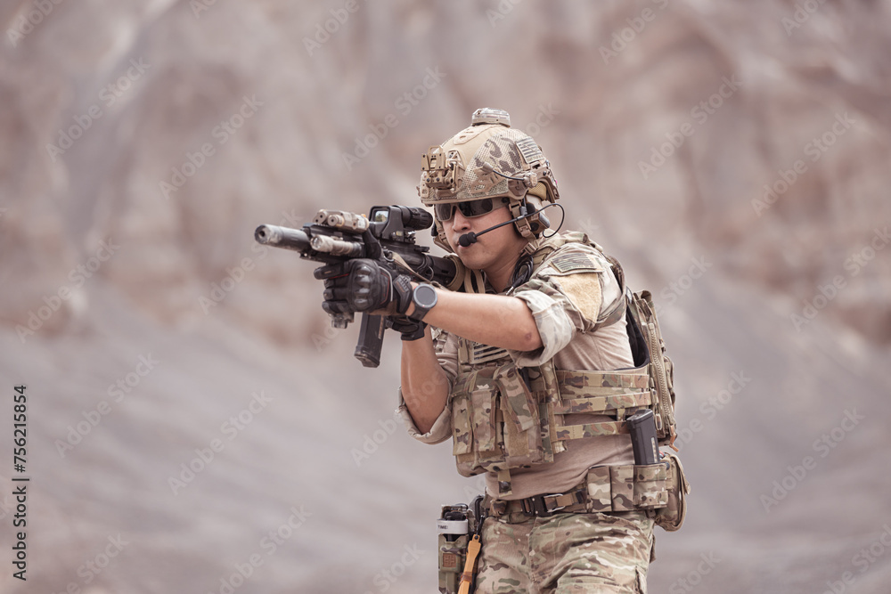 Fototapeta premium Soldiers in camouflage military uniforms carrying weapons, Reconnaissance missions in rugged mountains, Assault infantry battle training.