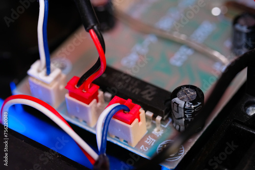 Macrophotography. Electrical closeup. Close up shot of the electrical circuit in an RC (Remote Control) Car. Background texture of PCB boards, cables, sockets and electronic devices. Shot with a macro