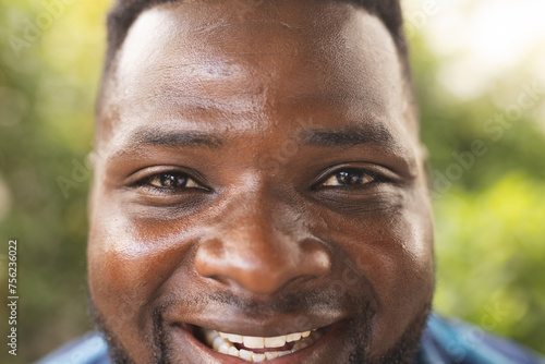 Close-up of a smiling African American man with short black hair photo