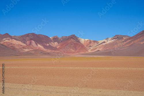 Multicoloured Desert Mountain Range, Blue Sky Background and Orange Sands - Salar de Uyuni, Bolivia 