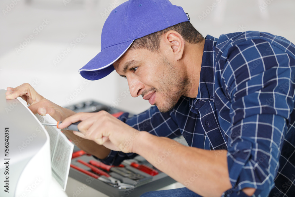 hardware repairman repairing broken printer fax machine hardware repairman repairing broken printer fax machine