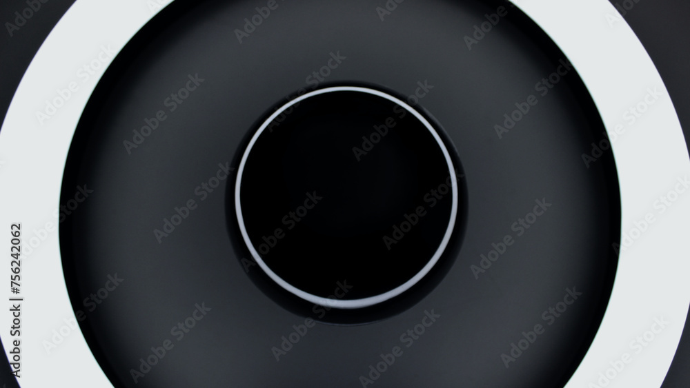 A black shiny sphere reflects glares from a ring lamp concept photo for space backgrounds
A black shiny sphere reflects glares from a ring lamp concept photo for space backgrounds