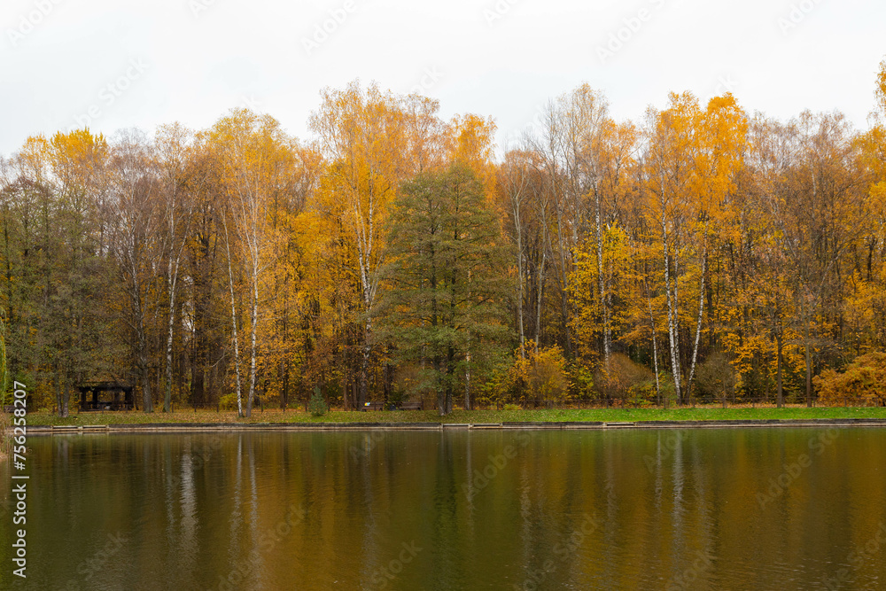 Lake reflections of autumn foliage. The colorful fall foliage is reflected in the calm waters of the European Lake. Lake reflections of autumn foliage. The colorful fall foliage is reflected in the calm waters of the European Lake.