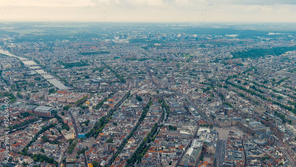 Amsterdam, Netherlands. Panorama of the city in the morning in cloudy weather. View of the Amstel River with locks, Aerial View