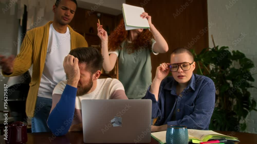 diverse team of freelancers work together on startup indoors. look narrowly at laptop awaiting results. multiethnic students get failure news and become disappointed and upset. diverse team of freelancers work together on startup indoors. look narrowly at laptop awaiting results. multiethnic students get failure news and become disappointed and upset.