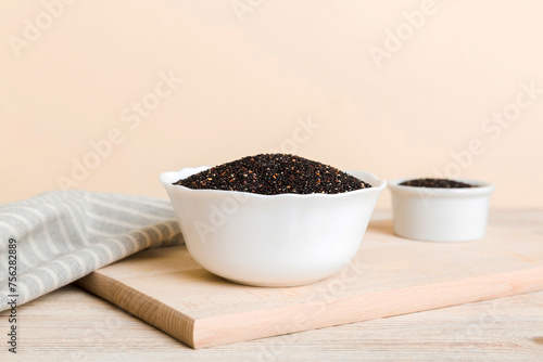 quinoa seeds in bowl on colored background. Healthy kinwa in small bowl. Healthy superfood