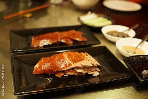 Roasted honey Peking duck served with Chinese pancake roll, spring onions, cucumber and sweet bean Hoisin sauce