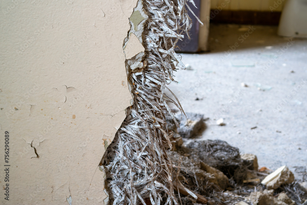 Old asbestos in a wall in the room, harmful to health