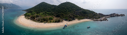 Panoramic aerial drone view of spectacular white sand beach of tropical Hon Nua Island off the Central Vietnam coast, surrounded by the pristine turquoise water of the South China Sea photo