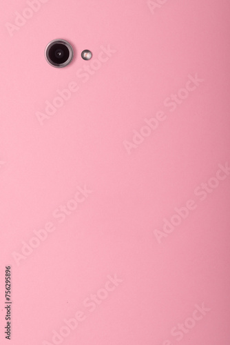  Minimalist modern concept of social media, blogging, and filling content for social media. Smartphone camera on pink background with copy space.