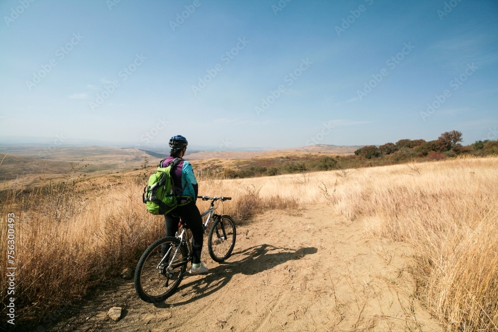 A cyclist admires the view of the steppe, Russia.