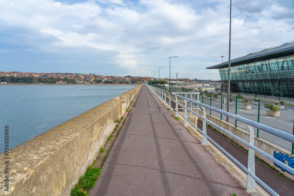Jetty with 1 km of pedestrian access to the lighthouse with surrounding urban landscape. Getxo-Basque Country-Spain. 3-3-2024