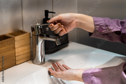 Woman cleaning her hand at the wastafel. healthy concept