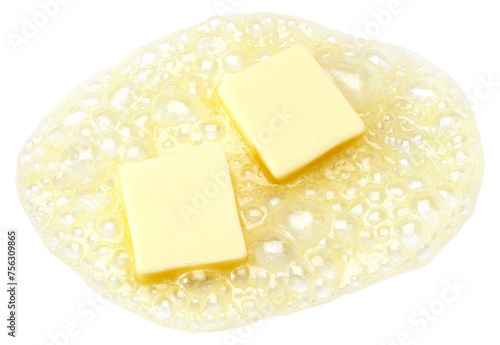 Foto Two pieces of butter melting isolated