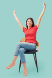 Cheerful woman celebrating with raised arms