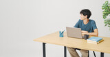 Student sitting at his desk and looking away