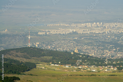Cityscape of Tbilisi, Georgia. Modern and old parts of city. Churches and TV tower. Tbilisi water reservoir - Tbilisi sea is visible.