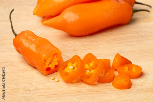 Sliced fresh raw Peruvian Aji Amarillo pepper close up   photo