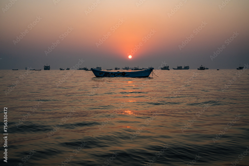 Centered fishing boat at sunset Centered fishing boat at sunset