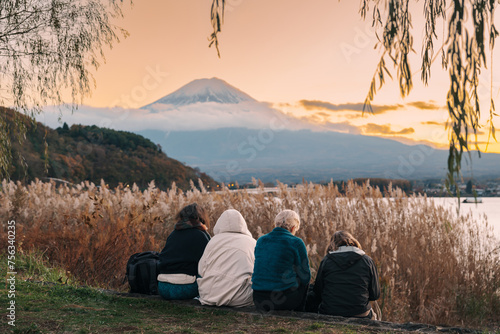 Family tourists enjoy with Fuji Mountain at Lake Kawaguchi , happy friends group travel and sightseeing Mount Fuji view. Landmark for tourists attraction. Japan Travel, Destination and Vacation photo