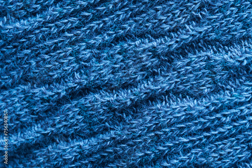 Warm and cozy blue textile wool material - fabric. Background or backdrop. Diagonal fibers. Photo. Macro