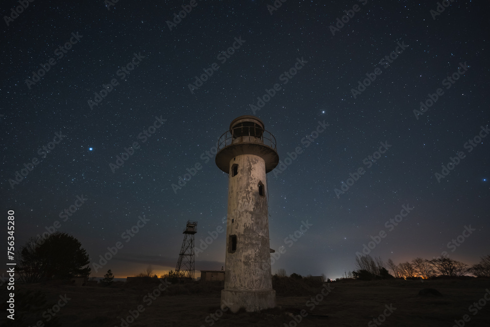 Old lighthouse and border observation tower on the shore of the Baltic Sea in Estonia.