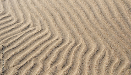 closeup of sand pattern of a beach in the summer with ripple marks; vertical image