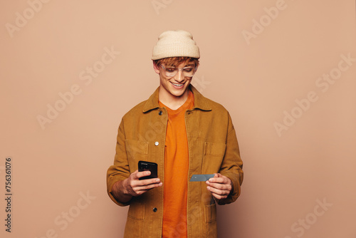Happy man smiling while using a modern banking app on his smartphone