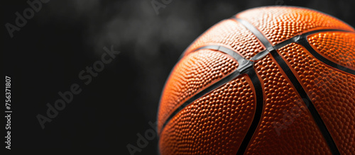 A basketball is shown in close up on a black background