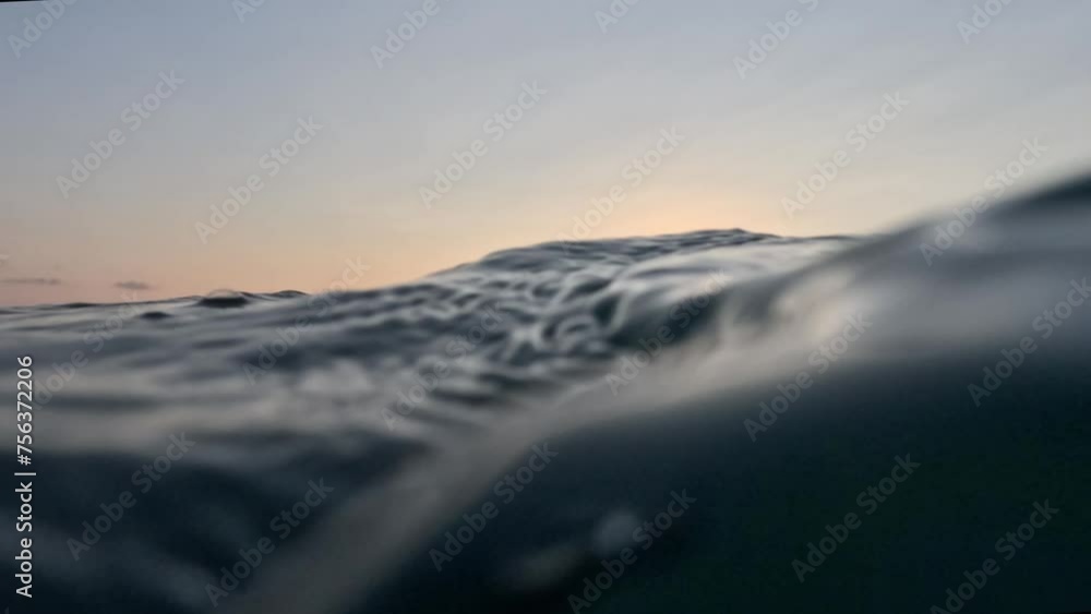 View from the surface of the sea at sunset. Chilling on the sea waves and watching the setting sun go below the horizon View from the surface of the sea at sunset. Chilling on the sea waves and watching the setting sun go below the horizon