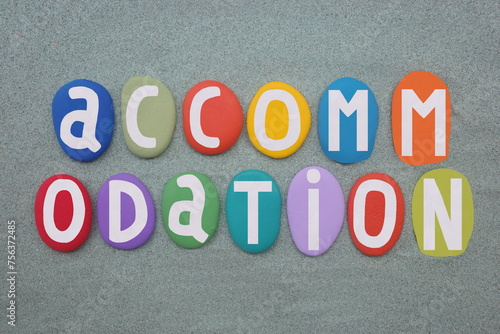 Accommodation, a room, group of rooms, or building in which someone may live or stay, creative text composed with hand painted multi colored stone letters over green sand