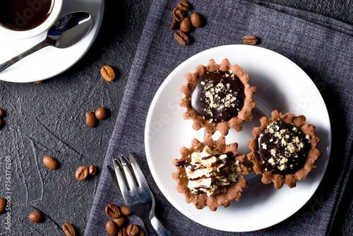 Chocolate baskets with nut cream. Homemade tartlets with cream and glaze © shandor_gor