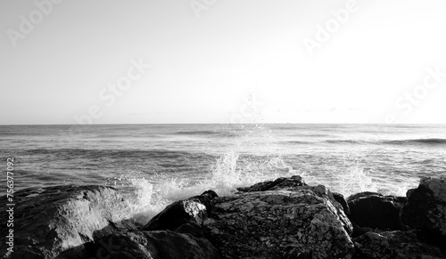 Waves breaking on rocks on the cliffs and foaming, sea and ocean views, wild seas, black and white 