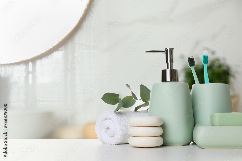 Bath accessories. Different personal care products and eucalyptus leaves on white table in bathroom, space for text