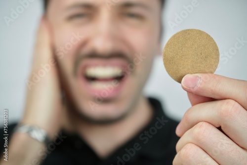 Person holding tinnitus treatment patch 