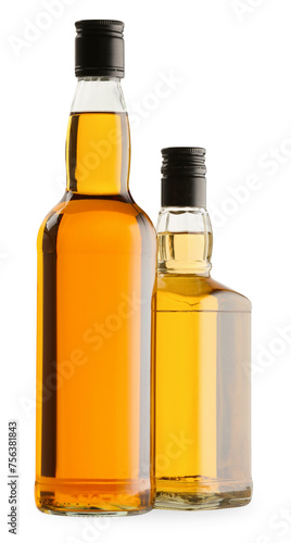 Different sorts of whiskey in glass bottles isolated on white