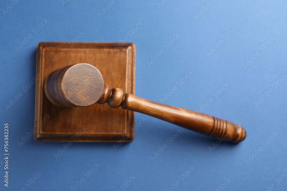 Wooden gavel and sound block on blue table, top view Wooden gavel and sound block on blue table, top view