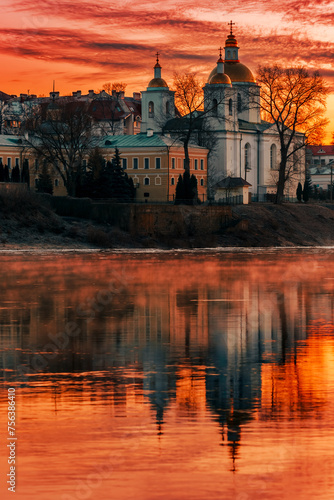 Mirror reflection in the water of the Epiphany Cathedral and the dawn red sky. City of Polotsk, Western Dvina River, Belarus. © Yury Kisialiou