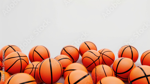 A bunch of orange basketballs are piled up on a white background © kiatipol