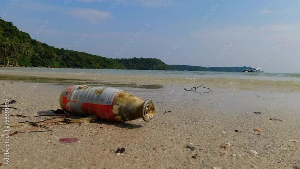 A mudslide on the beach spews solid waste and glass bottle, drawing attention to the environmental consequences. Environmental Science and Solid Waste A mudslide on the beach spews solid waste and glass bottle, drawing attention to the environmental consequences. Environmental Science and Solid Waste